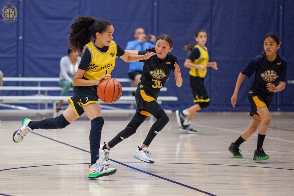 Ares Basketball girl athlete Leah during game action.