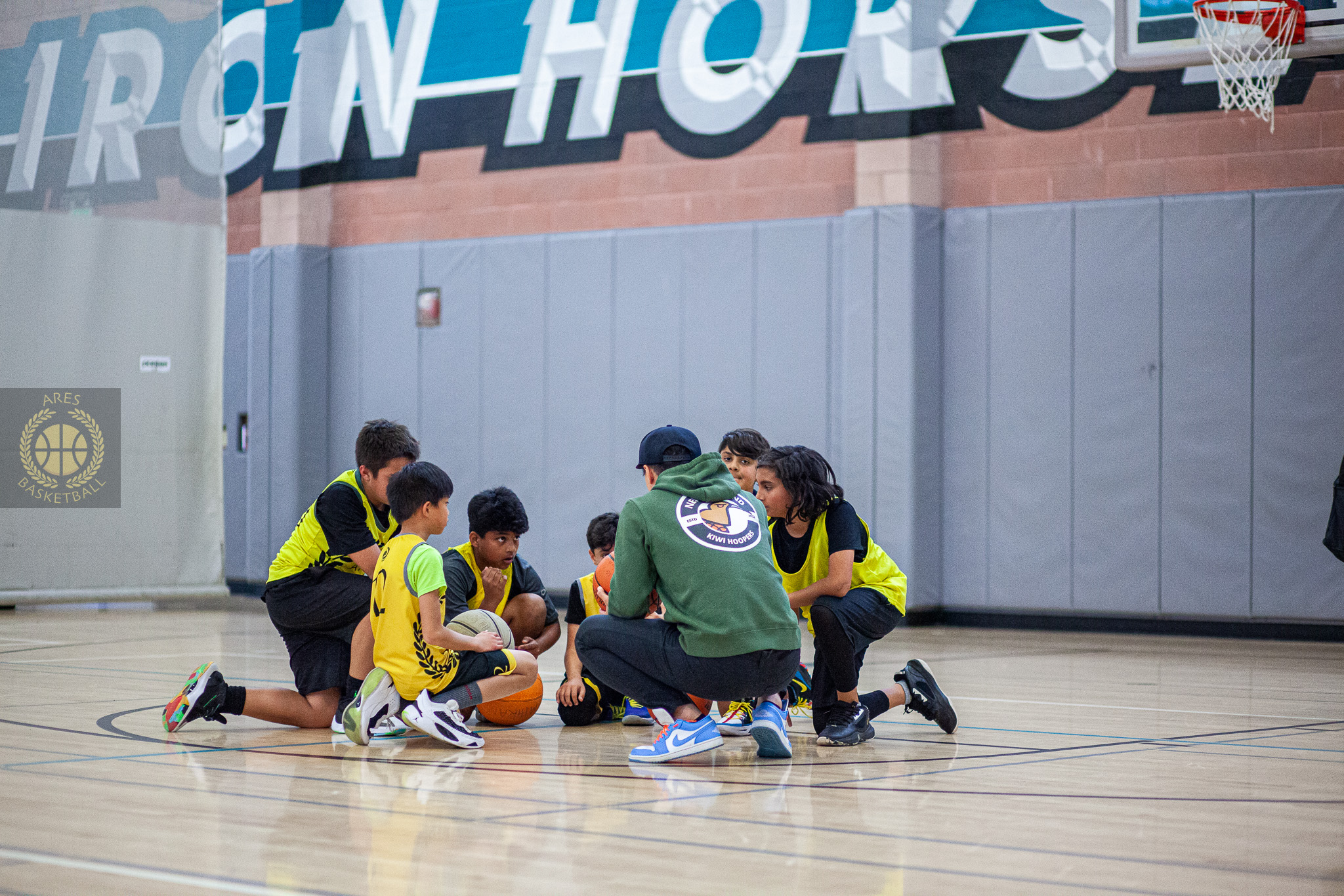 basketball team reviewing the game plan mid court